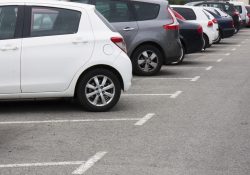 Estacionar em frente a uma guia rebaixada causa multa?